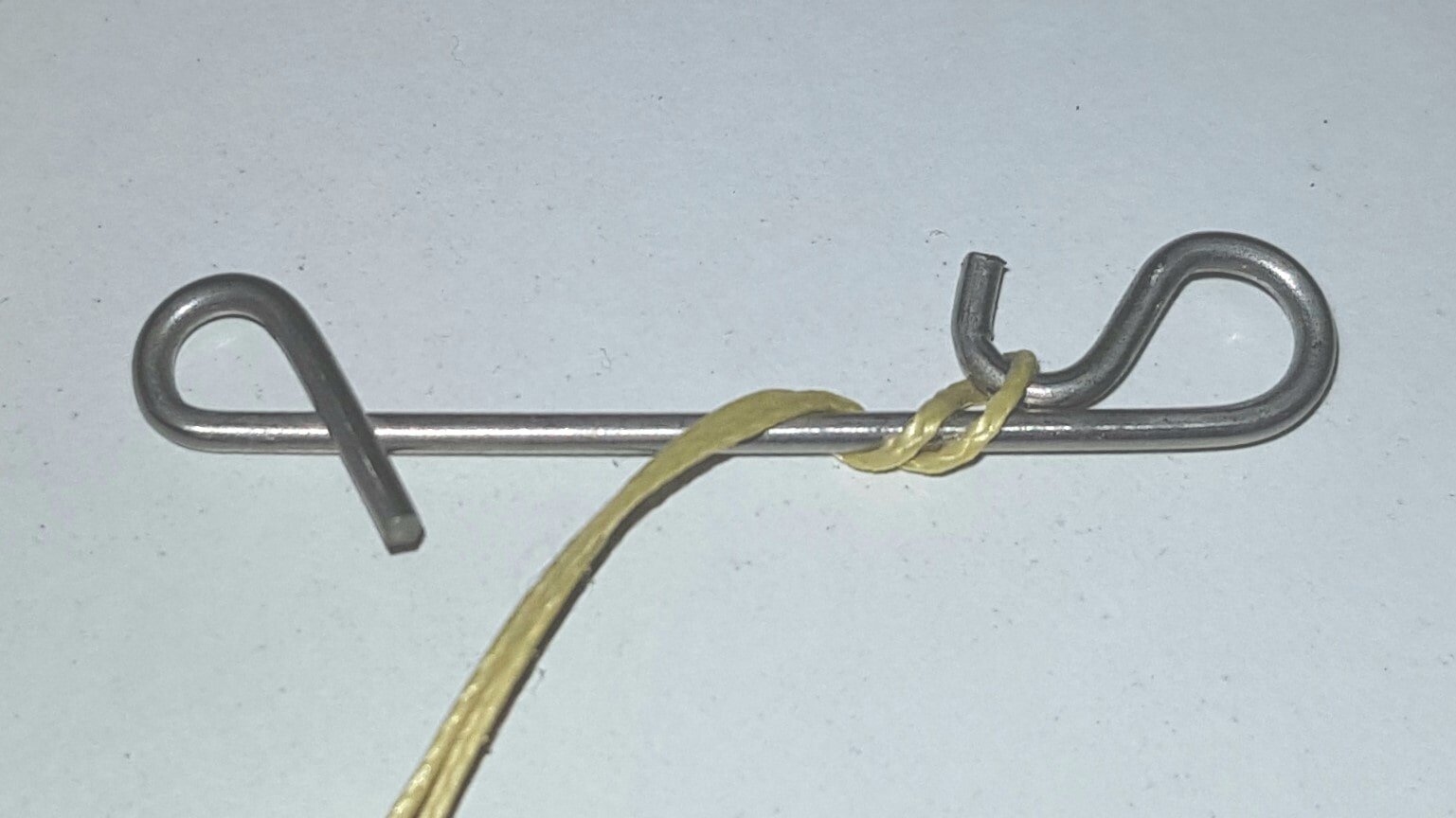 Nahaufnahme, ein Schnurverbinder ist einmal mit einer geflochtenen Schnur umwickelt.